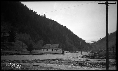 The ongoing flood in Wallace, Idaho. The water is rushing up to an already damaged house.
