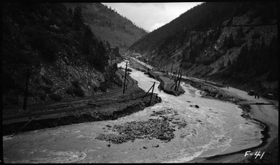Damaged road and railroad due to flooding. Flood waters have created a complete break in the road.