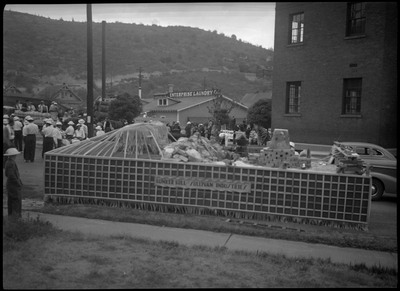Front view of the Bunker Hill and Sullivan Industries parade float which has various materials stacked on top of the float.