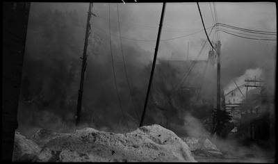 Smoke obscures the buildings during the Ryan Hotel and Tabor Building fire. Snow can be seen in the foreground.