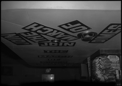 Text for a March of Dimes display in block letters on the ceiling.  A stand with snacks can be seen on the right.