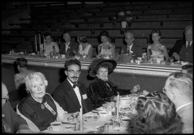 People sitting at tables and dressed in formal wear during the Silver Jubilee banquet.