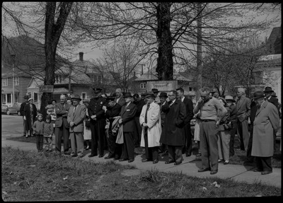 A group of people watch the Stardust Motel dedication from the sidewalk.