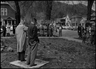 Two men standing on piece of wood and addressing the crowd during the Stardust Motel dedication.