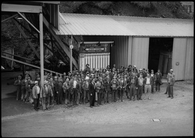 Group photograph of the workers at the Galena plant receiving the Galena Safety Award. They are standing in front of a safety board.