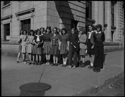 Fourteen girls standing on a curb during Boys and Girls Week.