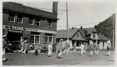 A group of marchers pass by as part of the Memorial Day parade.
