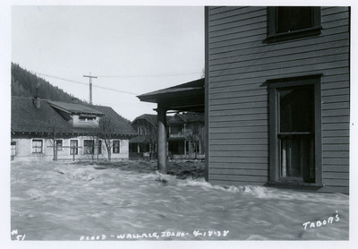 Water rushes past several buildings during a flood in Wallace, Idaho.