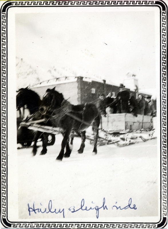 A group of people ride in a sleigh pulled by horses. "Hailey sleigh ride" is written on the front of the photo.