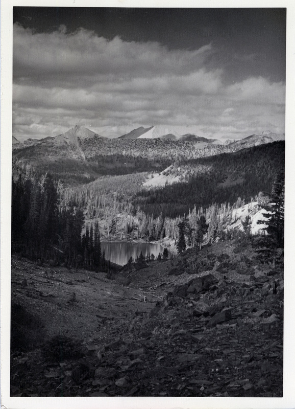 A pool of water is visible at the base of a mountain range.