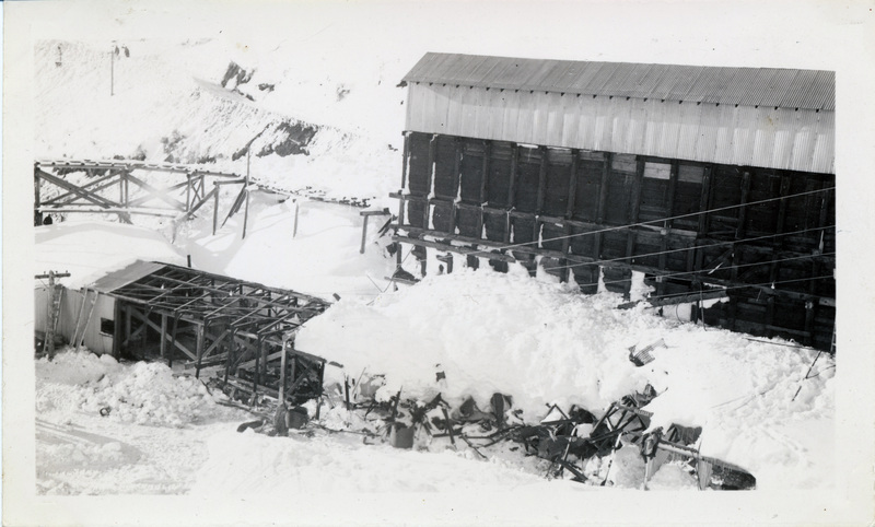 Mining structures which have been partially crushed by snow. The back of the photograph is stamped with the number 12.