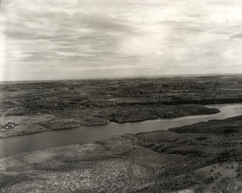 A view from above of a stream near a town. A label on the back reads "011 Hagerman from West."