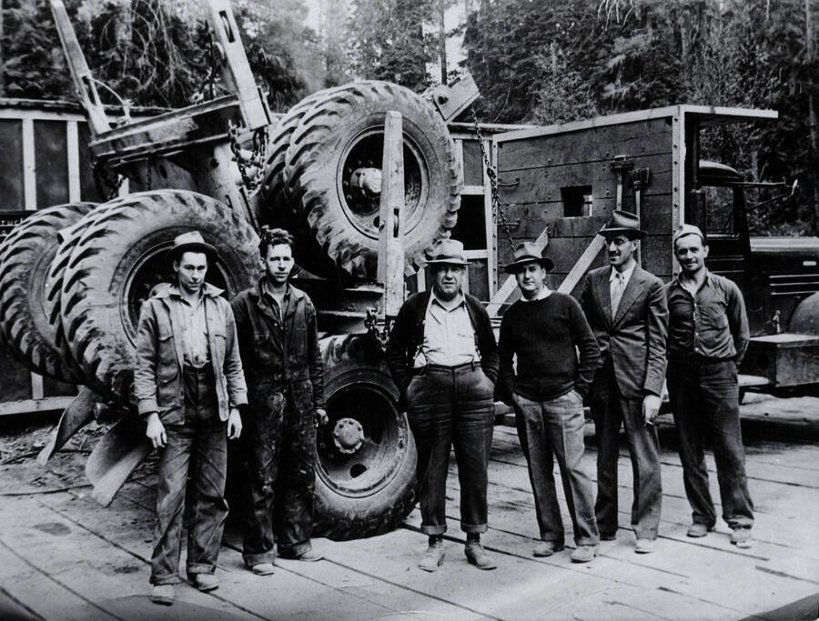 Logging truck and workers. Second from left: Johnny Zagelow. Third from left: C. G. Nogle. Fourth from left: Julius Crane.