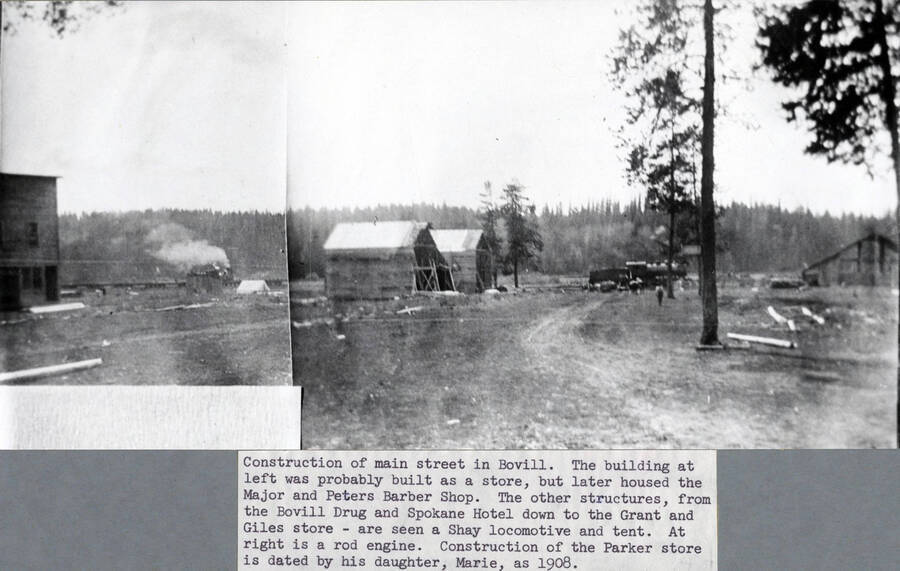 Construction of the main street in Bovill. The building at left was probably first built as a store, but later housed the Major and Peters Barber Shop. The other structures are the frames of the E.K. Parker store and the Sherman House. Through the gap--later filled by other structures, from the Bovill Drug and Spokane Hotel down to the Grant and Giles store--are seen a Shay locomotive and tent. At right is a rod engine. Construction of the Parker store is dated by his daughter, Marie, as 1908.