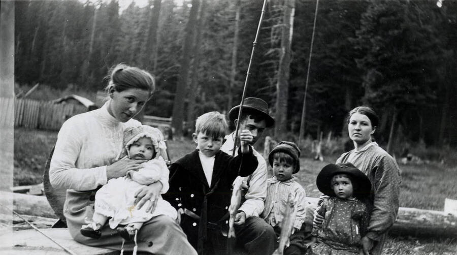 A group (with freshly caught trout) at the Hobbs cabin on Little Meadow about 1916. From left to right: Gertrude Hale Witty (holding Bernard Hobbs), Lee Witty, Dudley Hobbs, Bryan Hobbs, Evelyn Hobbs and Nellie Hobbs.
