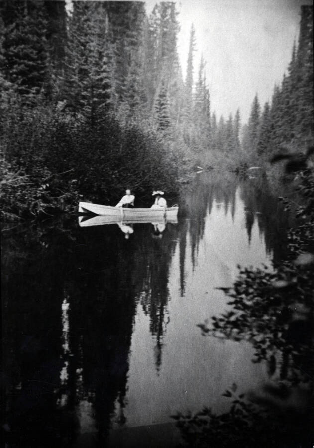 Ralston and Zunie' is the only reference to the identity of these two guests. They are pictured boating near the bend of the river about a quarter mile below the present town of Bovill. The view looks north towards the meadow.