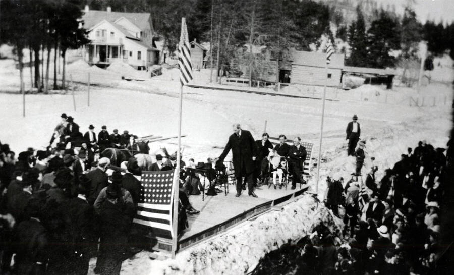 Speeches were made at Armistice Day ceremony in Bovill. Not positively identified, the speaker shown here is probably banker Bill Nelson. At the far right on the platform in T.P. Jones.