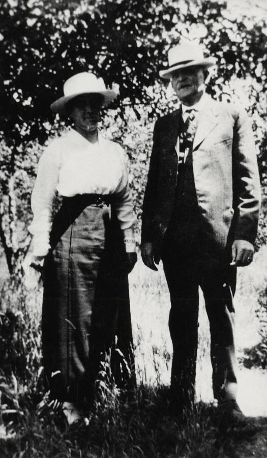 Mr. and Mrs. E.K. Parker pictured standing amongst some trees.