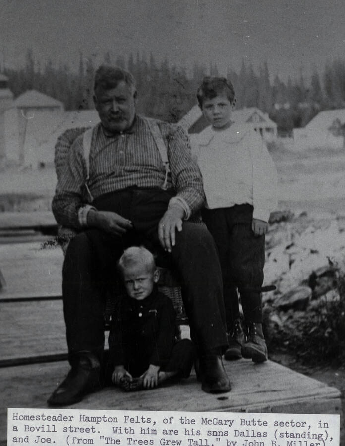 Homesteader Hampton Felts with his sons Dallas (standing) and Joe on a street in Bovill, Idaho.