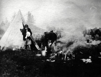 Chief Yellow Bull [Chuslum Mox Mox, Tsu Thlim Mukhs Mukhs], Nez Perce Indian, and his wife camped in the meadow in front of the Bovill place.