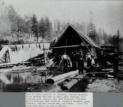 Water mill on Bear Creek, owned by Nils Burklund. Left to right: Mr. Erickson, Charlie Bergland, Fritz Reubaum, Milt Burkland, Nils Burklund, A.M. Johnson, Mrs. Milt Burkland, Millie Burkland, Anna Burklund, Josephine Bergland, Agnes Bergland, unknown man, Joe Carmen.