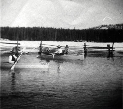 Hugh and Charlotte Bovill pictured rowing canoes through a flooded meadow