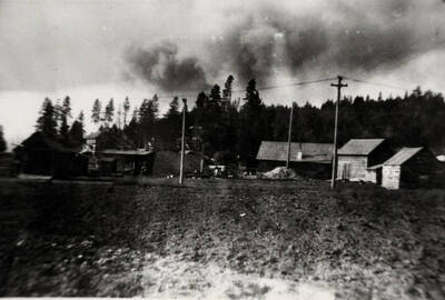 Houses in Bovill Idaho. Smoke from the Marble Creek forest fire above ridge.
