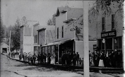 Buildings from right to left: Sherman House, E.K. Parker store, and a confectionary/lunch counter.