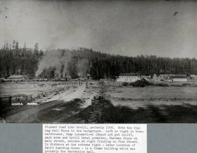 Pioneer road into Bovill, probably 1909. Note the zig-zag rail fence in the background. Left to right in town: warehouses, Shay locomotives (depot not yet built), park area and Bovill Hotel premises, Sherman House on main street, saloons at right fronting on Pine Street. In the distance at extreme right - later location of David Boarding House - is a frame which was probably the recreation hall.