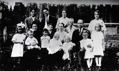 From Trees Grew Tall: 'The A.A. Anderson family. Rear row (left to right): Minnis, Dinnis, and Buelah, and (standing slightly forward) Kyle in front of Dinnis), Clay, and Kate. In front (left to right): Laura, Mrs. Anderson--a sister-in-law--with Sally in her lap, Ellis, Elizabeth with baby Sally in her lap, Elizabeth (daughter), Mr. A.A. Anderson, Mabel, and Christie.'