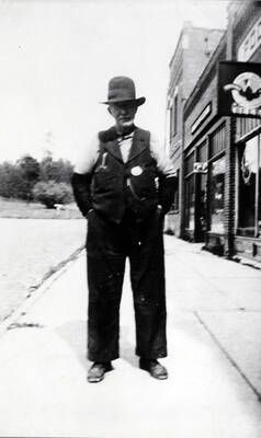 Deputy Sheriff Pat Malone stands on the sidewalk
