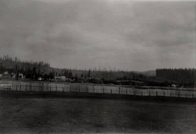 Chapin Cedar Yard looking east. This view shows the north half of the cedar yard. The ballpark fence is in the foreground and the cedar yard water tank is beyond it at far left. The cedar yard office is on the right.
