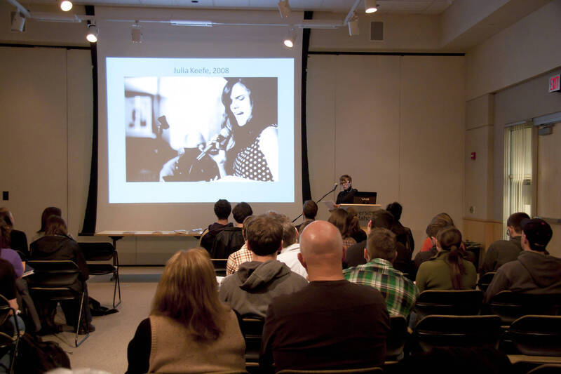 Photograph  7 of Janis Johnson's Colloquium Talk 'This Is the Sound of Survivance: Nez Perce Indians Playing Jazz.' Janis Johnson is Assistant Professor English. Pictured: Janis Johnson and audience.