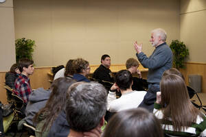 Photograph  13 of Bill Voxman's Colloquium Talk and Gallery Exhibition 'Communicating Communication through Black and White Photography: Connecting the Diverse with the Shared in Common.' Bill Voxman is Photographer and Professor Emeritus of Mathematics. Voxman's photographs were displayed in the UI Commons Reflections Gallery from January 9 to 27, 2012. Pictured: Bill Voxman talks with audience.