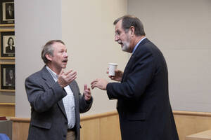 Photograph  3 of Marty Peterson's Colloquium Talk 'Reflections on Serving under Seven University of Idaho Presidents - Representing the University in all its Diversity and Universality.' Marty Peterson is Special Assistant to the President, Governmental Relations. Pictured: Marty Peterson talks to audience member before his colloquium talk.