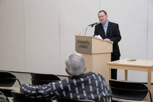 Photograph  7 of Brandon Schrand's Colloquium Talk 'Removing the Mask: The Personal Essay as an Epistemological Instrument in the Unique and the Universal.' Brandon Schrand is Assistant Professor of English. Pictured: Brandon Schrand talks to audience member.