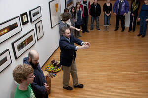 Photograph  22 of Barry Bilderback's Workshop and Performance 'Akwaaba and the Organization of Traditional Music and Dance in Ghanaian Culture.' Barry Bilderback is Assistant Professor of Music. Navin Chettri and World Beat were partners for the performance. Pictured: Barry Bilderback and audience participants at UI Prichard Gallery.