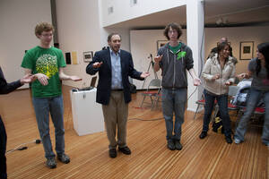 Photograph  32 of Barry Bilderback's Workshop and Performance 'Akwaaba and the Organization of Traditional Music and Dance in Ghanaian Culture.' Barry Bilderback is Assistant Professor of Music. Navin Chettri and World Beat were partners for the performance. Pictured: Barry Bilderback and audience participants at UI Prichard Gallery.
