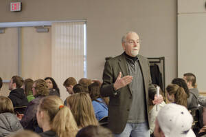 Photograph  2 of Sally Graves Machlis and Delphine Keim-Campbell's Colloquium Talk and Gallery Exhibition 'Road Stories.'  Sally Graves Machlis is Chair and Professor of Art and Design. Dephine Keim-Campbell is Associate Professor of Art and Design. Pictured: Professor Rodney Frey introduces Machlis and Campbell.