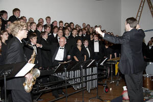 Photograph  1 of Dan Bukvich with Navin Chettri and the Jazz Choir I's Musical Performance 'The Village Sings and Drums and Dances, an evening of engaged voices and rhythms.' Dan Bukvich is Professor of Music. Navin Chettri is Bukvich's student. Pictured: Dan Bukvich and Jazz Choir I, University of Idaho Prichard Gallery.