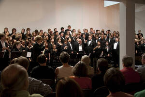 Photograph  2 of Dan Bukvich with Navin Chettri and the Jazz Choir I's Musical Performance 'The Village Sings and Drums and Dances, an evening of engaged voices and rhythms.' Dan Bukvich is Professor of Music. Navin Chettri is Bukvich's student. Pictured: Dan Bukvich and Jazz Choir I, University of Idaho Prichard Gallery.