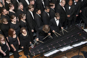 Photograph  8 of Dan Bukvich with Navin Chettri and the Jazz Choir I's Musical Performance 'The Village Sings and Drums and Dances, an evening of engaged voices and rhythms.' Dan Bukvich is Professor of Music. Navin Chettri is Bukvich's student. Pictured: Jazz Choir I, University of Idaho Prichard Gallery.
