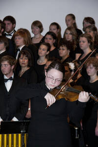 Photograph  11 of Dan Bukvich with Navin Chettri and the Jazz Choir I's Musical Performance 'The Village Sings and Drums and Dances, an evening of engaged voices and rhythms.' Dan Bukvich is Professor of Music. Navin Chettri is Bukvich's student. Pictured: Soloist and Jazz Choir I, University of Idaho Prichard Gallery.