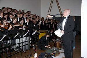 Photograph  20 of Dan Bukvich with Navin Chettri and the Jazz Choir I's Musical Performance 'The Village Sings and Drums and Dances, an evening of engaged voices and rhythms.' Dan Bukvich is Professor of Music. Navin Chettri is Bukvich's student. Pictured: Dan Bukvich and Jazz Choir I, University of Idaho Prichard Gallery.