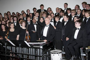 Photograph  21 of Dan Bukvich with Navin Chettri and the Jazz Choir I's Musical Performance 'The Village Sings and Drums and Dances, an evening of engaged voices and rhythms.' Dan Bukvich is Professor of Music. Navin Chettri is Bukvich's student. Pictured: Dan Bukvich and Jazz Choir I, University of Idaho Prichard Gallery.