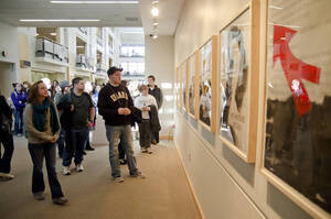 Photograph  10 of Sally Graves Machlis and Delphine Keim-Campbell's Colloquium Talk and Gallery Exhibition 'Road Stories.'  Sally Graves Machlis is Chair and Professor of Art and Design. Dephine Keim-Campbell is Associate Professor of Art and Design. Pictured: Students at opening reception for Road Stories in the Reflections Gallery, University of Idaho Commons.