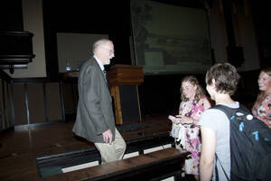 Photograph  13 of Rodney Frey's Keynote Address 'Turning of the Wheel: Meeting the Challenges and Charting - Creating the World with Spokes and a Hub.' Rodney Frey is Professor of Ethnography and Distinguished Humanities Professor. Pictured: Rodney Frey and audience members, Administration Auditorium, UI Moscow.