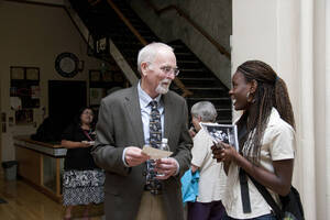 Photograph  17 of Rodney Frey's Keynote Address 'Turning of the Wheel: Meeting the Challenges and Charting - Creating the World with Spokes and a Hub.' Rodney Frey is Professor of Ethnography and Distinguished Humanities Professor. Pictured: Rodney Frey and audience member after his Keynote Address, Administration Auditorium, UI Moscow.