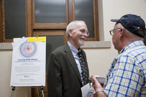 Photograph  18 of Rodney Frey's Keynote Address 'Turning of the Wheel: Meeting the Challenges and Charting - Creating the World with Spokes and a Hub.' Rodney Frey is Professor of Ethnography and Distinguished Humanities Professor. Pictured: Rodney Frey and audience member after his Keynote Address, Administration Auditorium, UI Moscow.