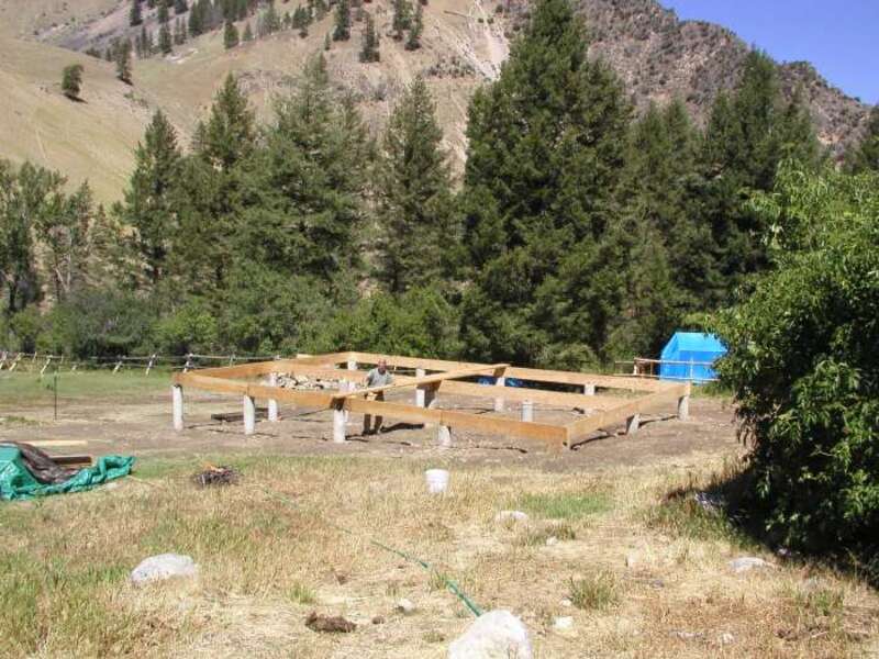 Ed Krumpe checks sub-floor beams for levelness.